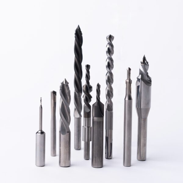 Professional metal drill bits and cutting tools set including twist drills, spade bits, and machining tools for metalworking and industrial applications arranged on white background