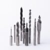 Professional metal drill bits and cutting tools set including twist drills, spade bits, and machining tools for metalworking and industrial applications arranged on white background